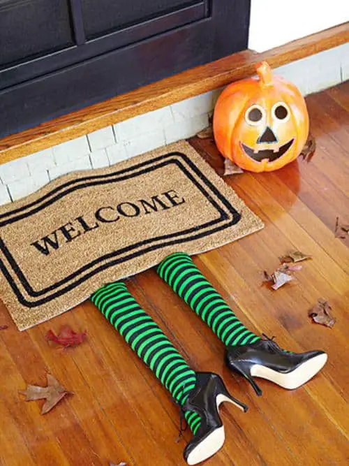 Witches Legs underneath Welcome Doormat